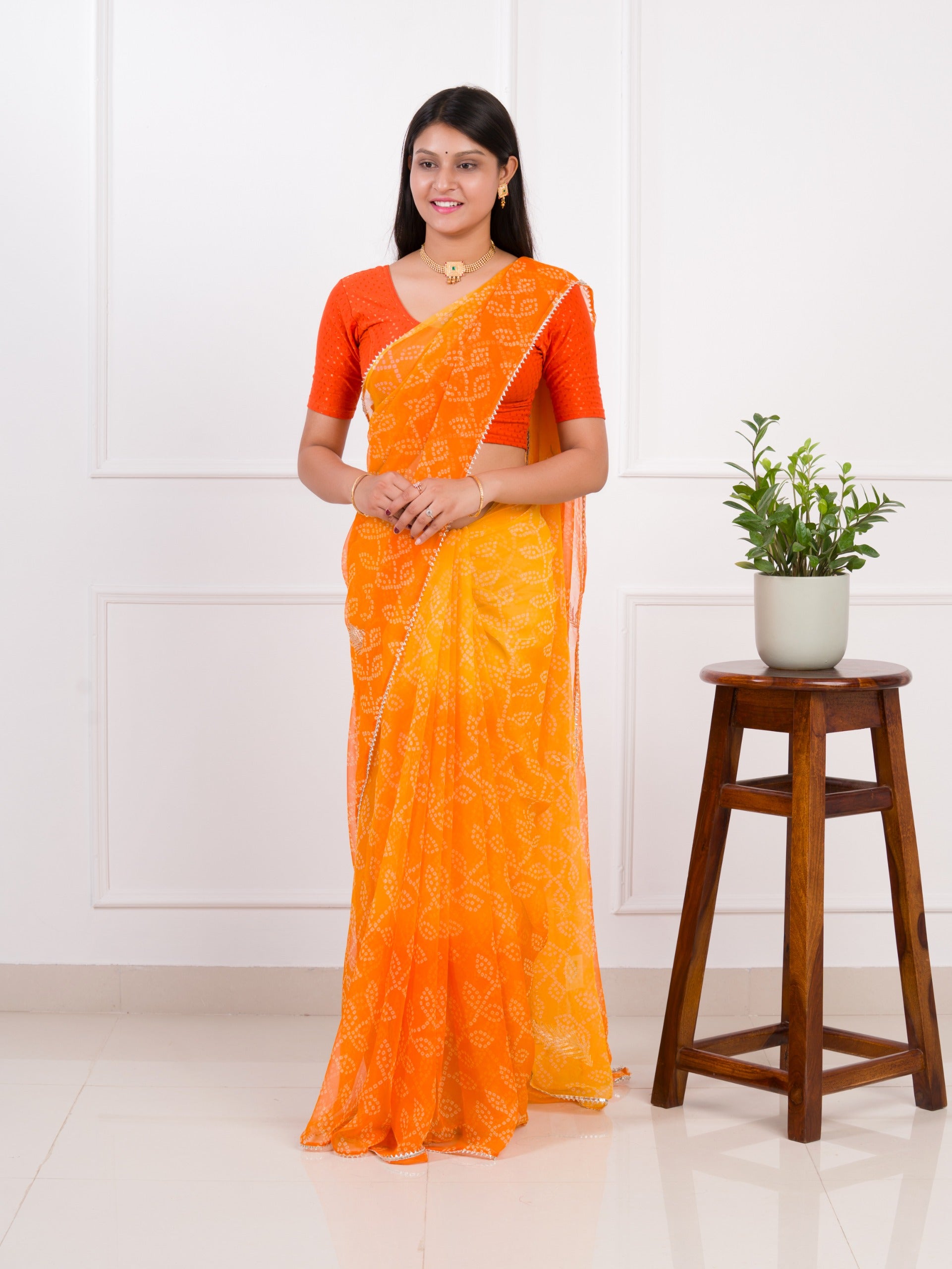 orange saree with a white printChiffon Bandhani style With Vintage Work Saree