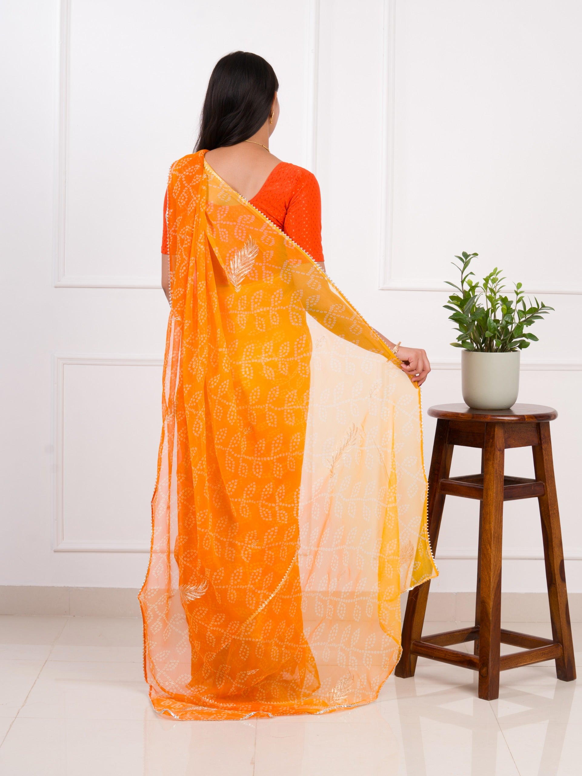 orange saree with a white printChiffon Bandhani style With Vintage Work Saree