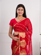 A red saree with gold patternsin Georgette Bandhani Style Saree