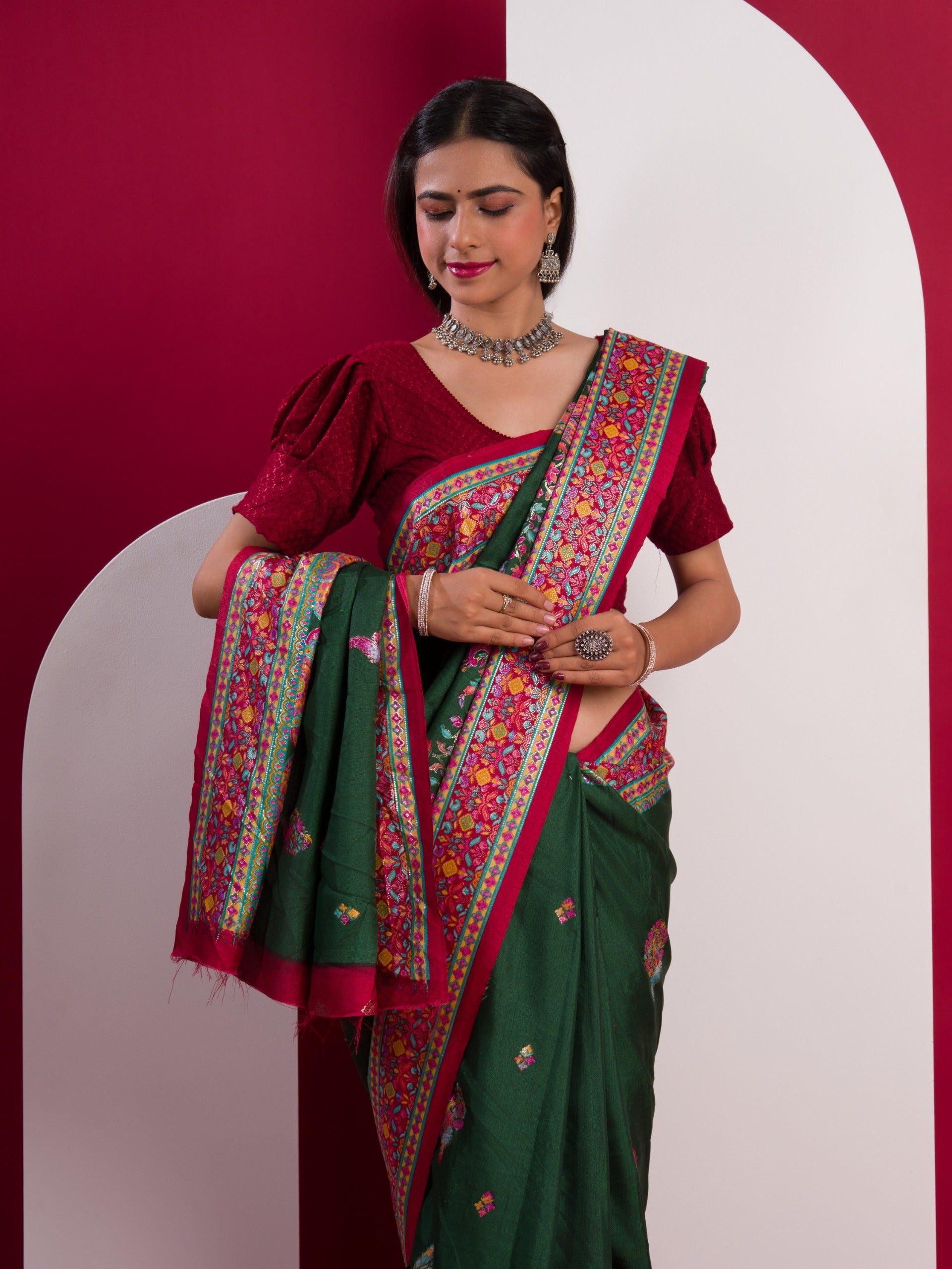 A green saree with a colorful borderin Dola Silk KalamkariStyle