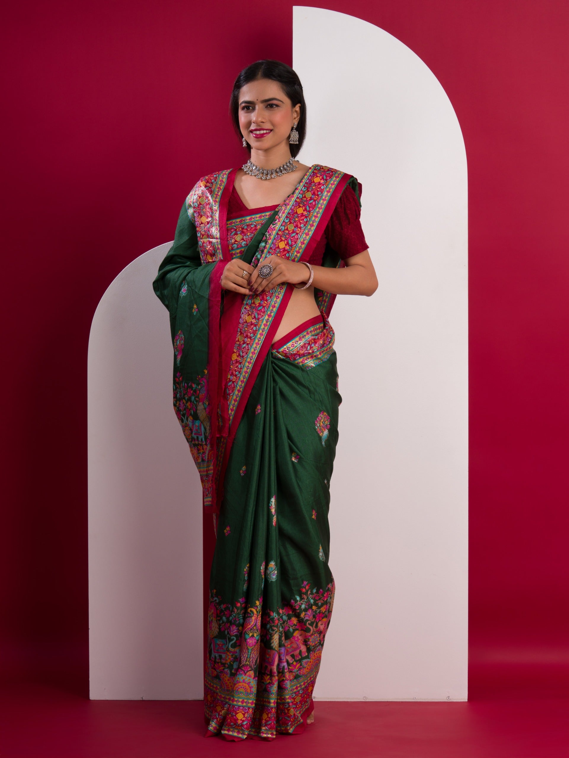 A green saree with a colorful borderin Dola Silk KalamkariStyle