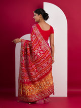 A pink saree with a red and gold border
