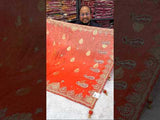 An orange saree with silver paisley pattern and floral gotapatti work, along with sequence embellishments.