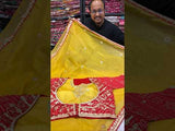 A yellow and red tissue silk saree with Bollywood style embellishments and gotapatti work.