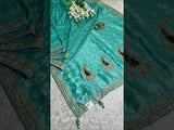 A green Banarsi silk saree with Bollywood style embellishments including sequins and gotapatti work