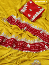 A yellow and red saree with gota patti work