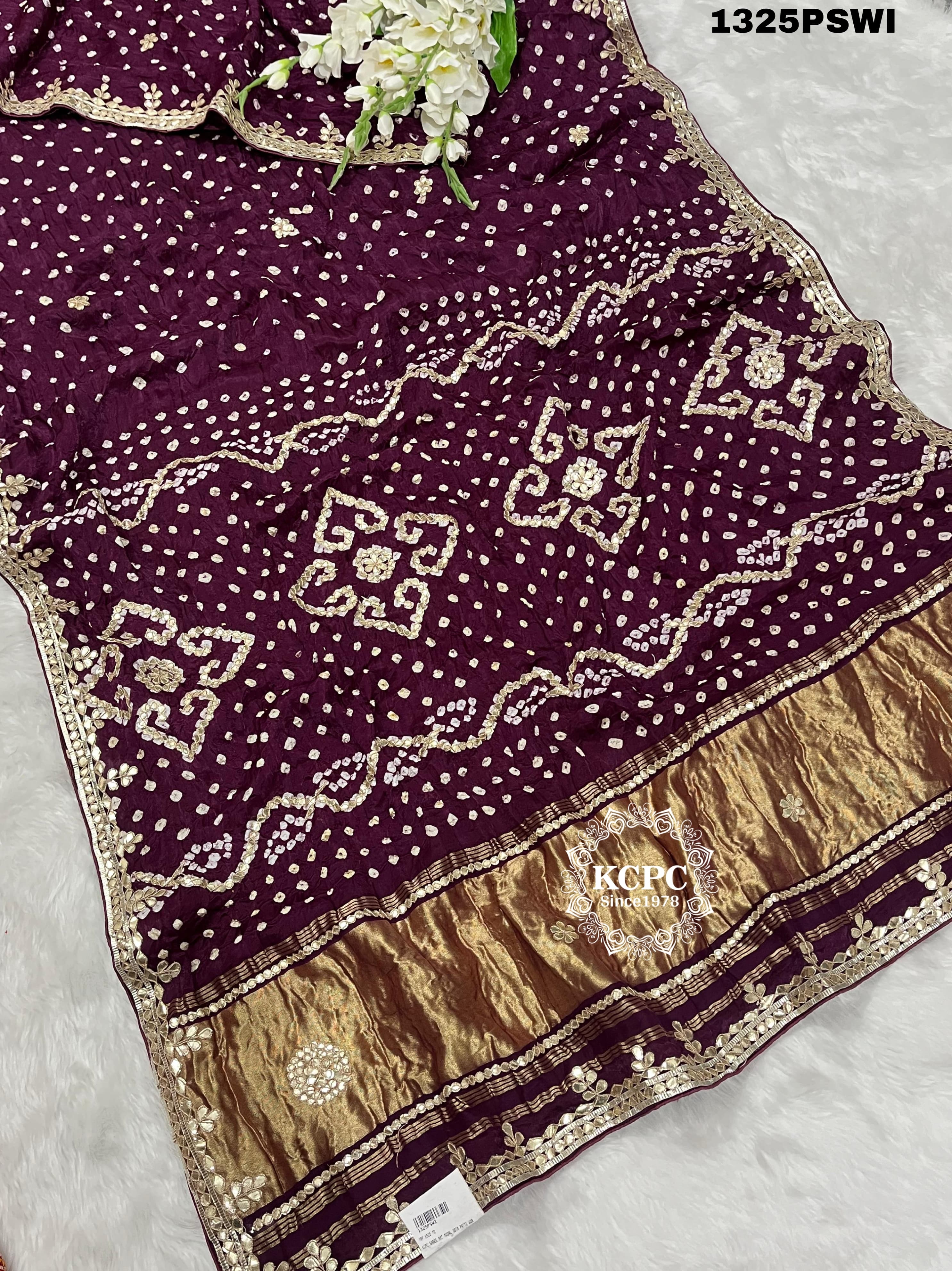 A purple and gold saree with gota patti work