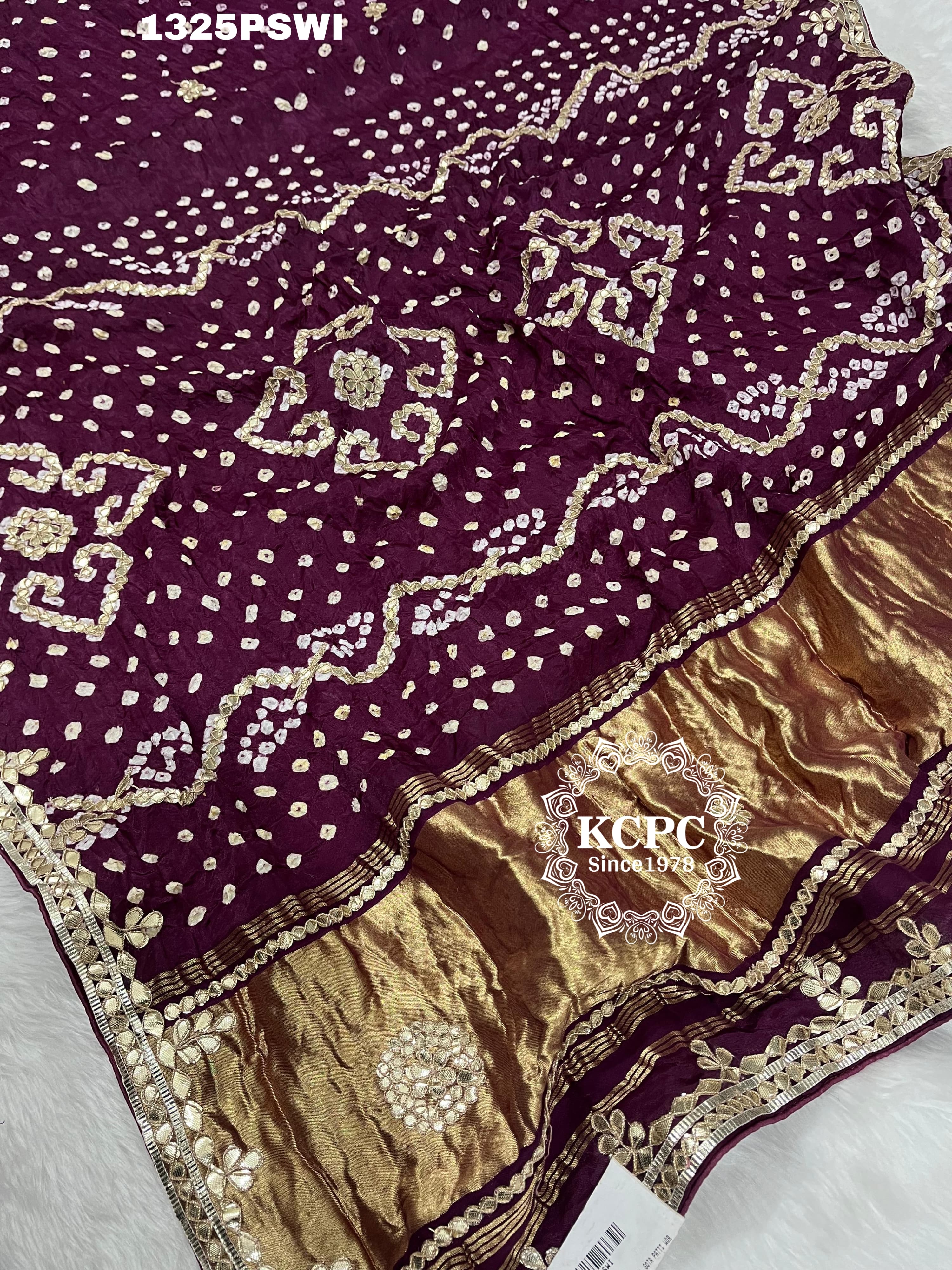A purple and gold saree with gota patti work