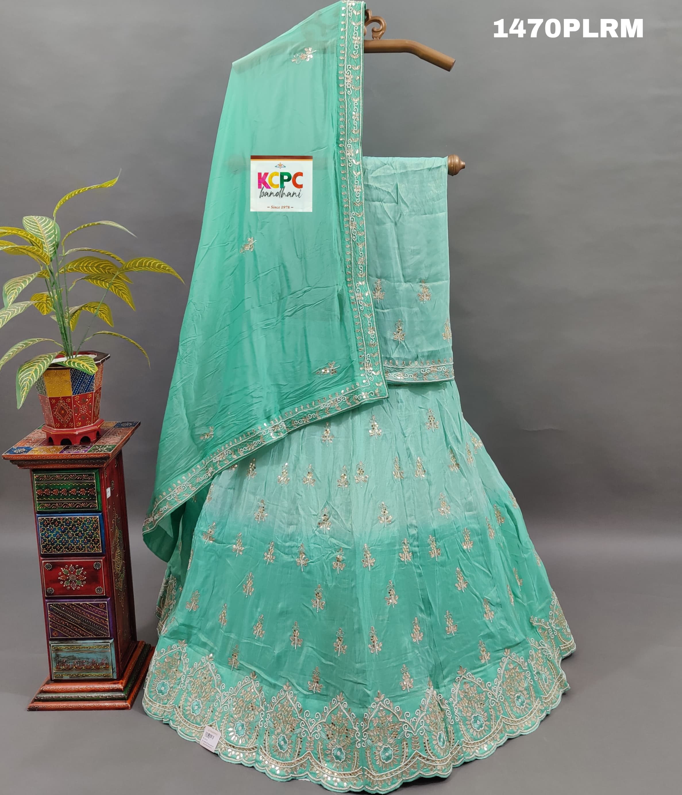 A green H O silk double shade heavy cutdana mirror work lehenga