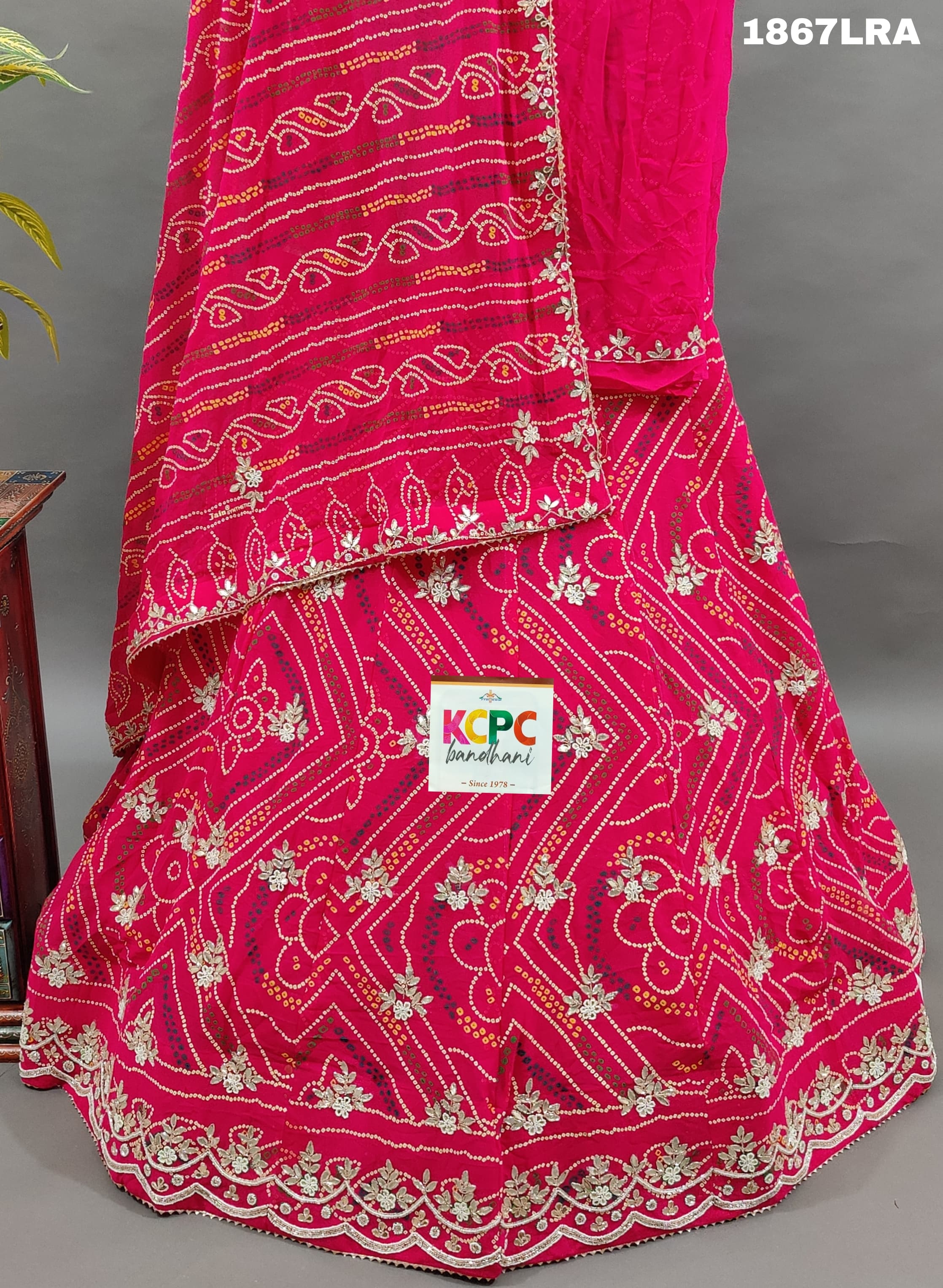 A pink georgette bandhej lehenga with cutdana gotapatti work