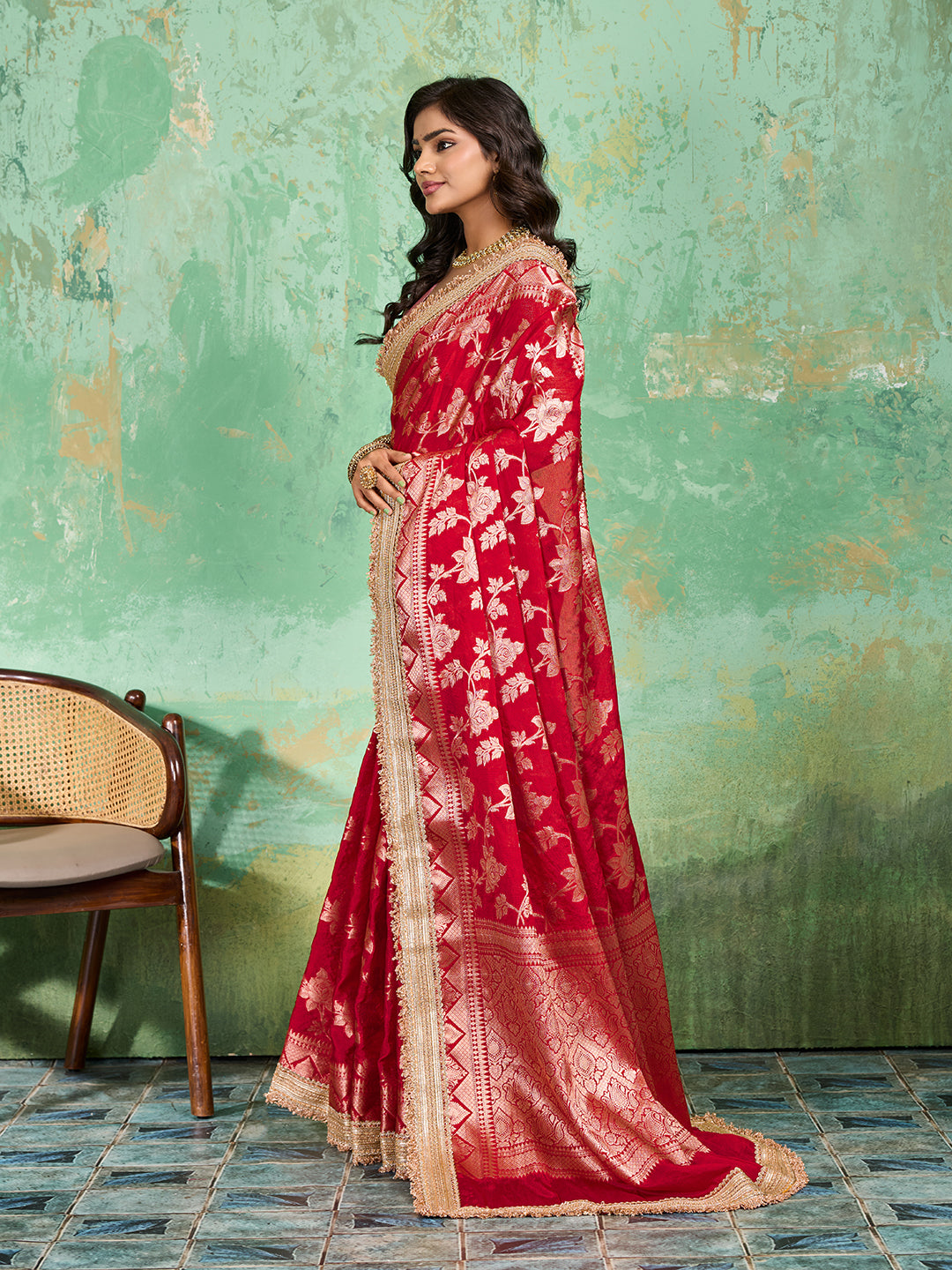 Woman in a red saree with gold borderTissue silk Banarasi Style 