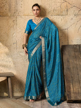 A blue chiffon georgette saree with bandhani print, featuring a sky blue color and decorative patterns, paired with a blue blouse.