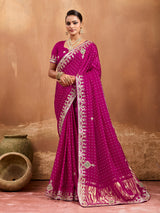 A pink modal silk saree with bandhani pattern and gotapatti work