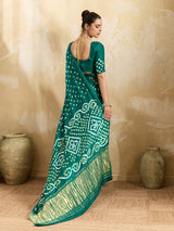  A traditional saree with a bandhani pattern in teal color,