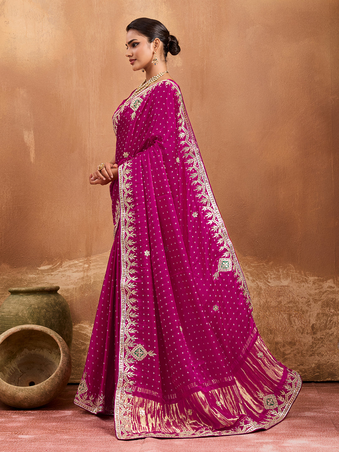 A pink modal silk saree with bandhani pattern and gotapatti work