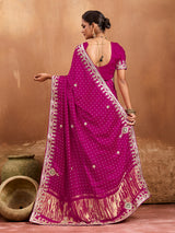 A pink modal silk saree with bandhani pattern and gotapatti work