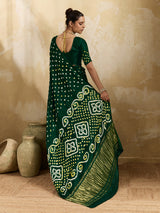 A bottle green saree with bandhani print and lagdi patola pallu, alongside a blouse piece.