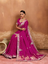 A pink modal silk saree with bandhani pattern and gotapatti work