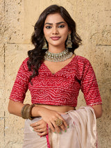 A white saree with red beads work and cutdana embellishments.