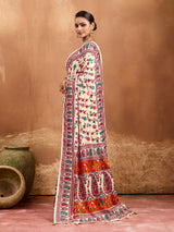  off-white saree with a floral and geometric pattern, featuring a heavy border and a small floral design on the fabric.