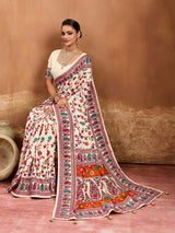  off-white saree with a floral and geometric pattern, featuring a heavy border and a small floral design on the fabric.