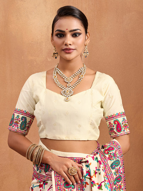 off-white saree with a floral and geometric pattern, featuring a heavy border and a small floral design on the fabric.