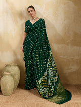 A bottle green saree with bandhani print and lagdi patola pallu, alongside a blouse piece.
