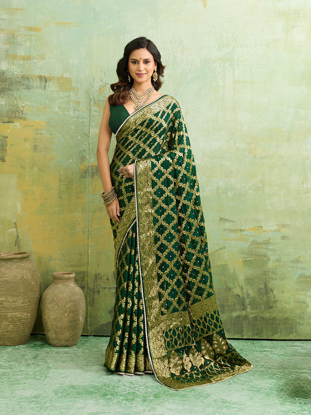 A bottle green Banarasi silk saree with heavy zari work and a gharchola pattern