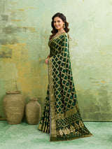 A bottle green Banarasi silk saree with heavy zari work and a gharchola pattern