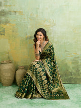 A bottle green Banarasi silk saree with heavy zari work and a gharchola pattern