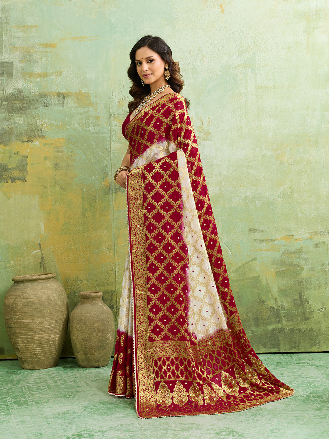 Banarasi silk saree with heavy zari work and a gharchola pattern in white and red colors