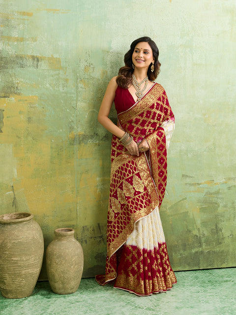 Banarasi silk saree with heavy zari work and a gharchola pattern in white and red colors
