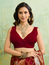 Banarasi silk saree with heavy zari work and a gharchola pattern in white and red colors