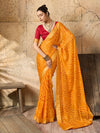 A yellow bandhani style chiffon georgette saree with a red blouse piece under 1000
