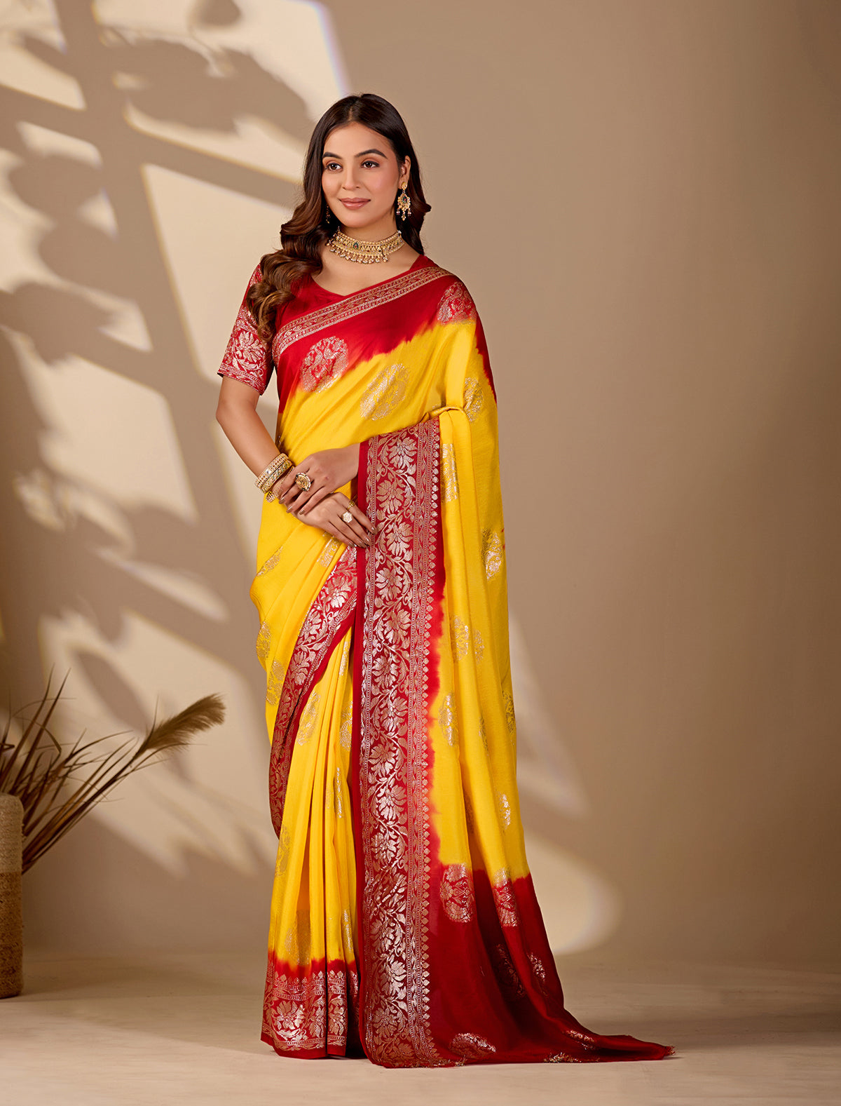 A yellow and red saree withPure Georgette Zari Faag Shadded Saree