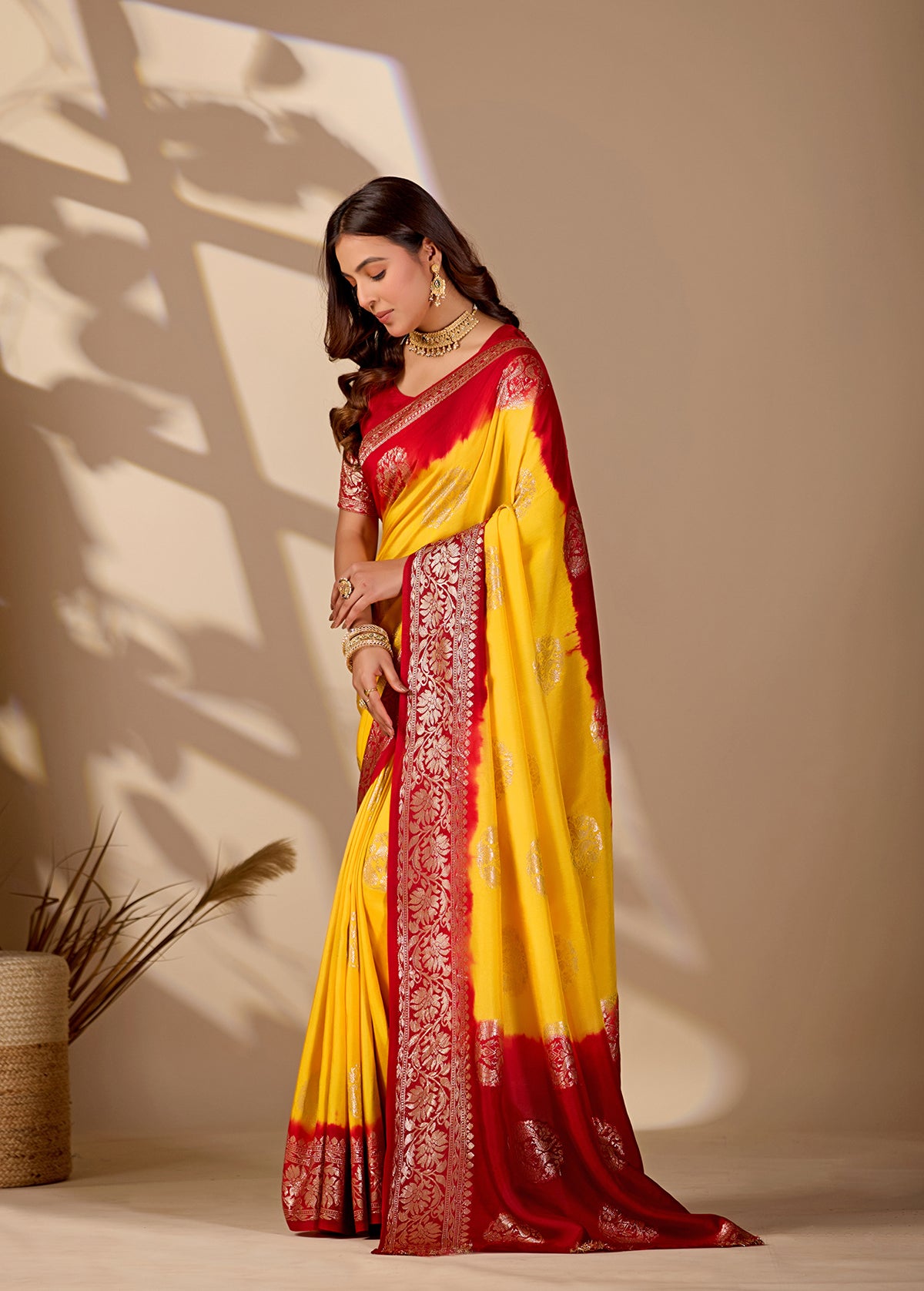 A yellow and red saree withPure Georgette Zari Faag Shadded Saree