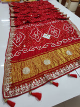 A red bandhani style sarees with gota patti embellishments
