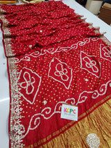 A red bandhani style sarees with gota patti embellishments