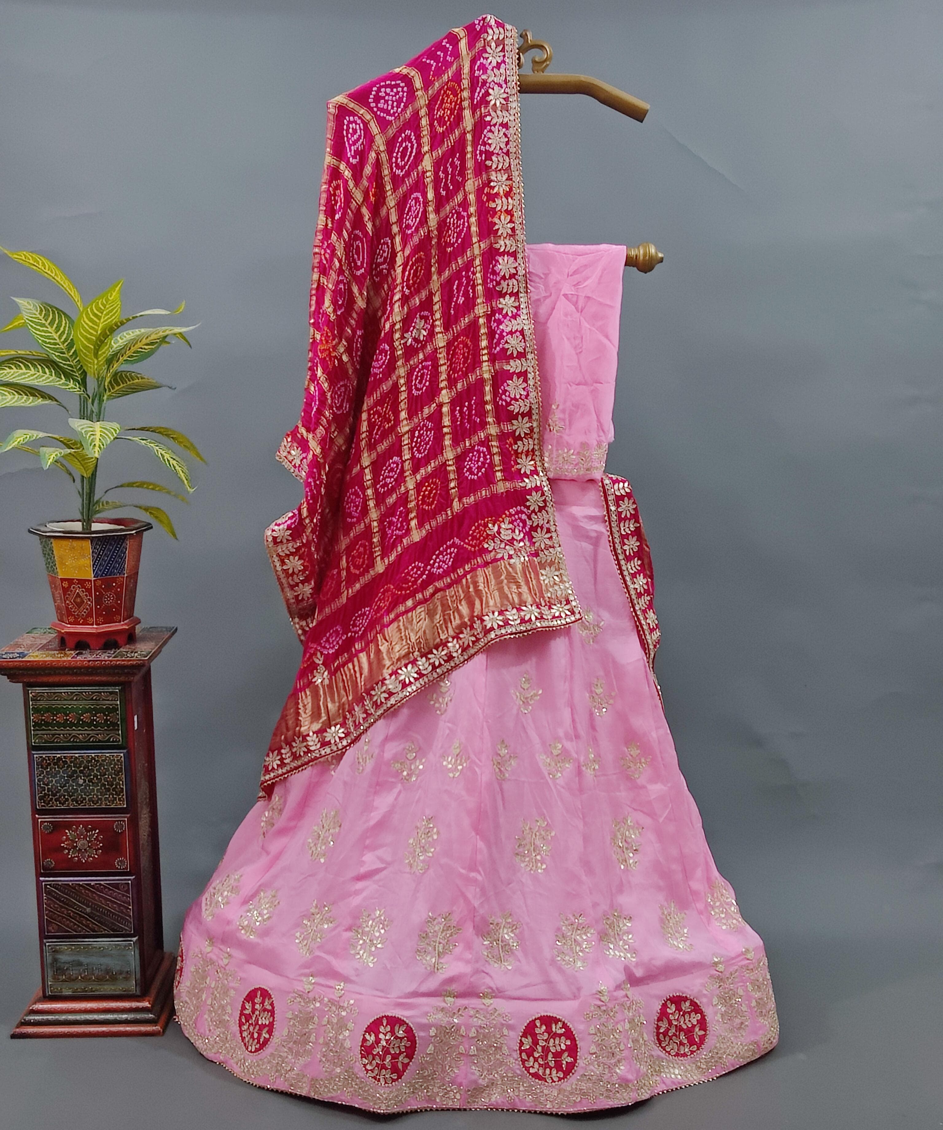 A pink lehenga set with dupatta and gotapati work