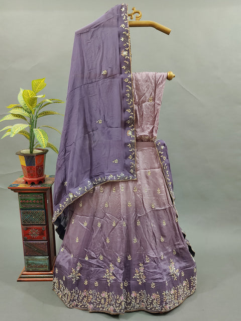 A traditional light purple lehenga with floral patterns and gota work