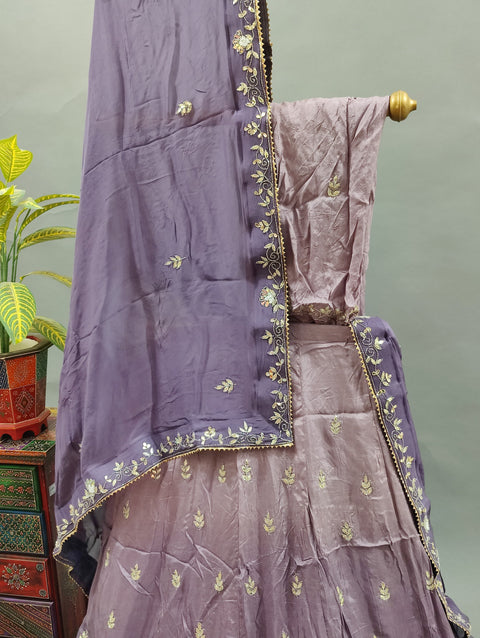 A traditional light purple lehenga with floral patterns and gota work