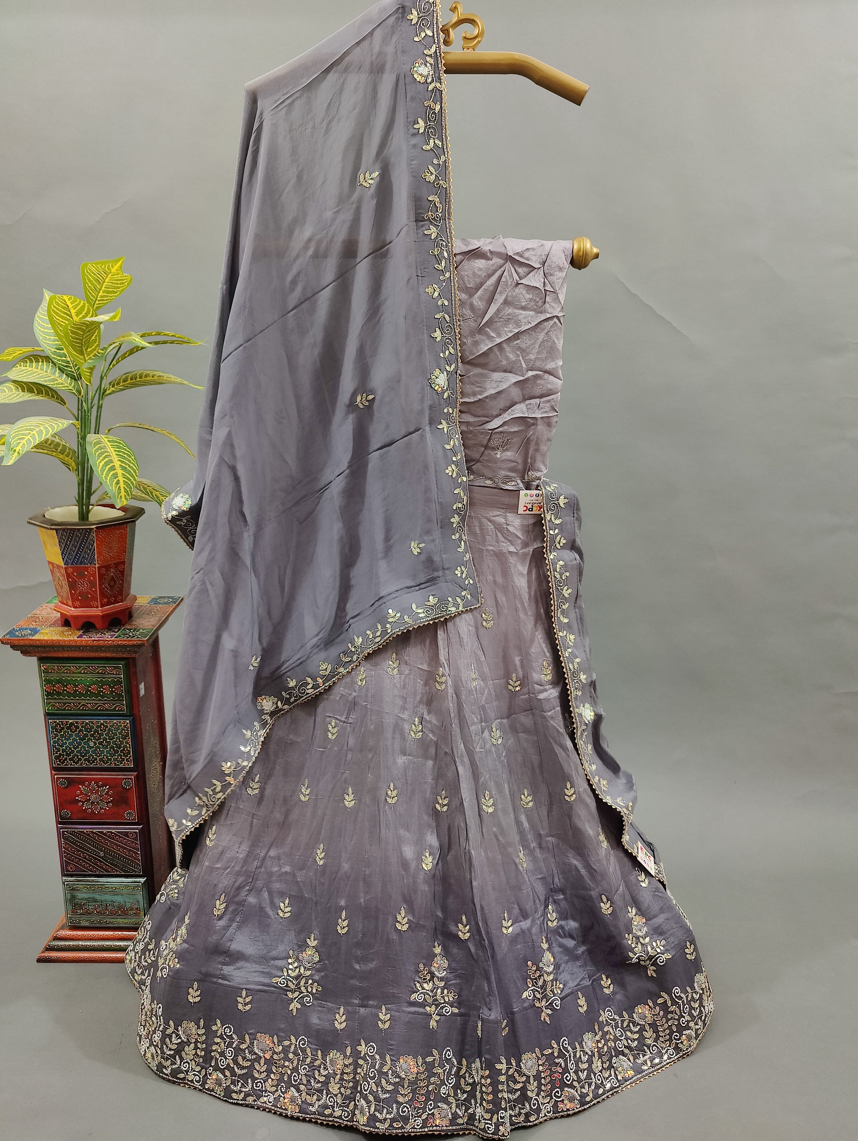 A traditional gray Lehenga with and a dupatta