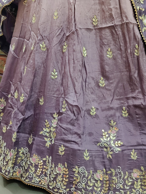 A traditional light purple lehenga with floral patterns and gota work