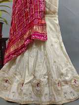 A traditional Indian lehenga with a dupatta, a pink and beige color 