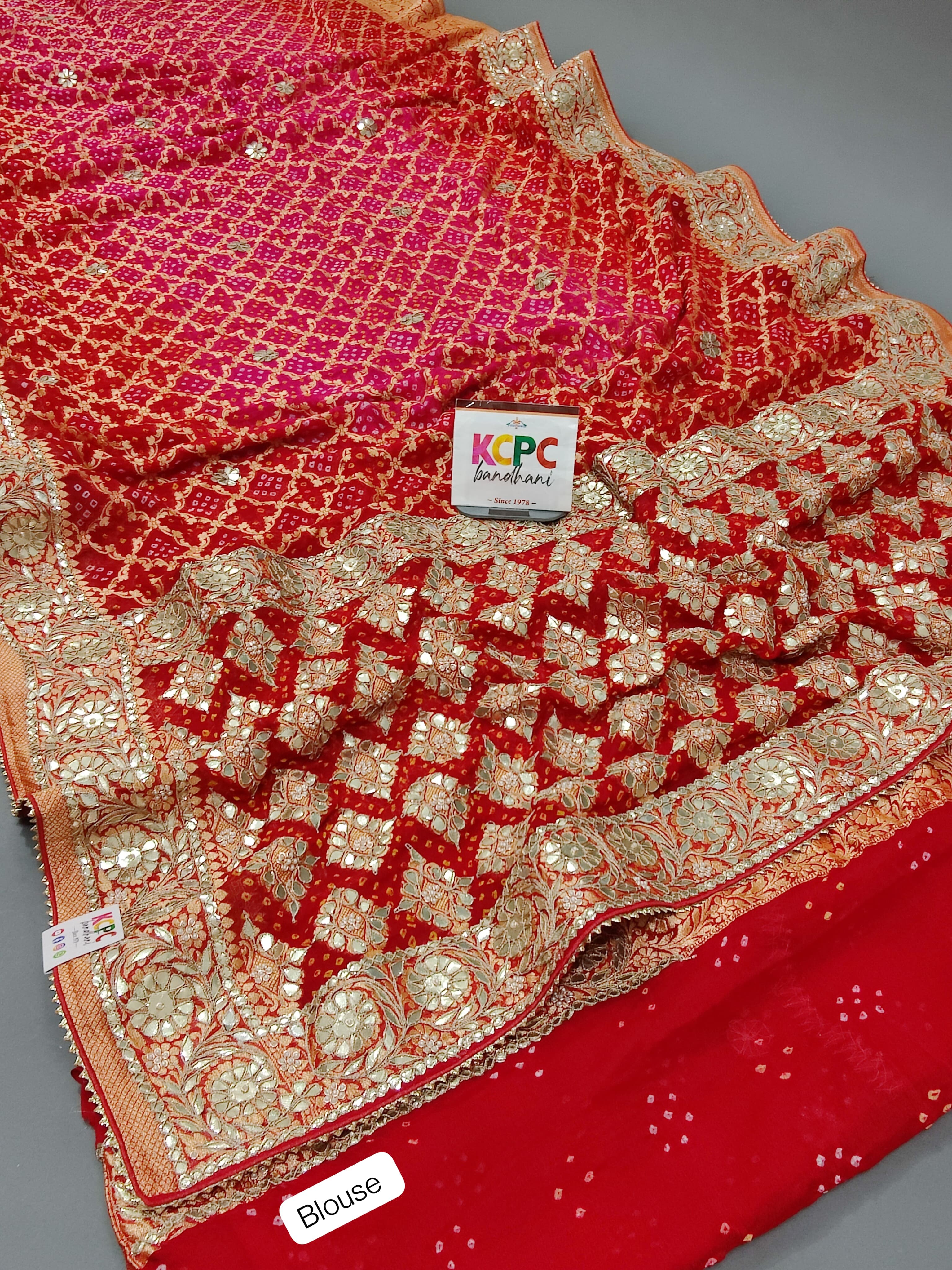A red georgette saree with gota patti