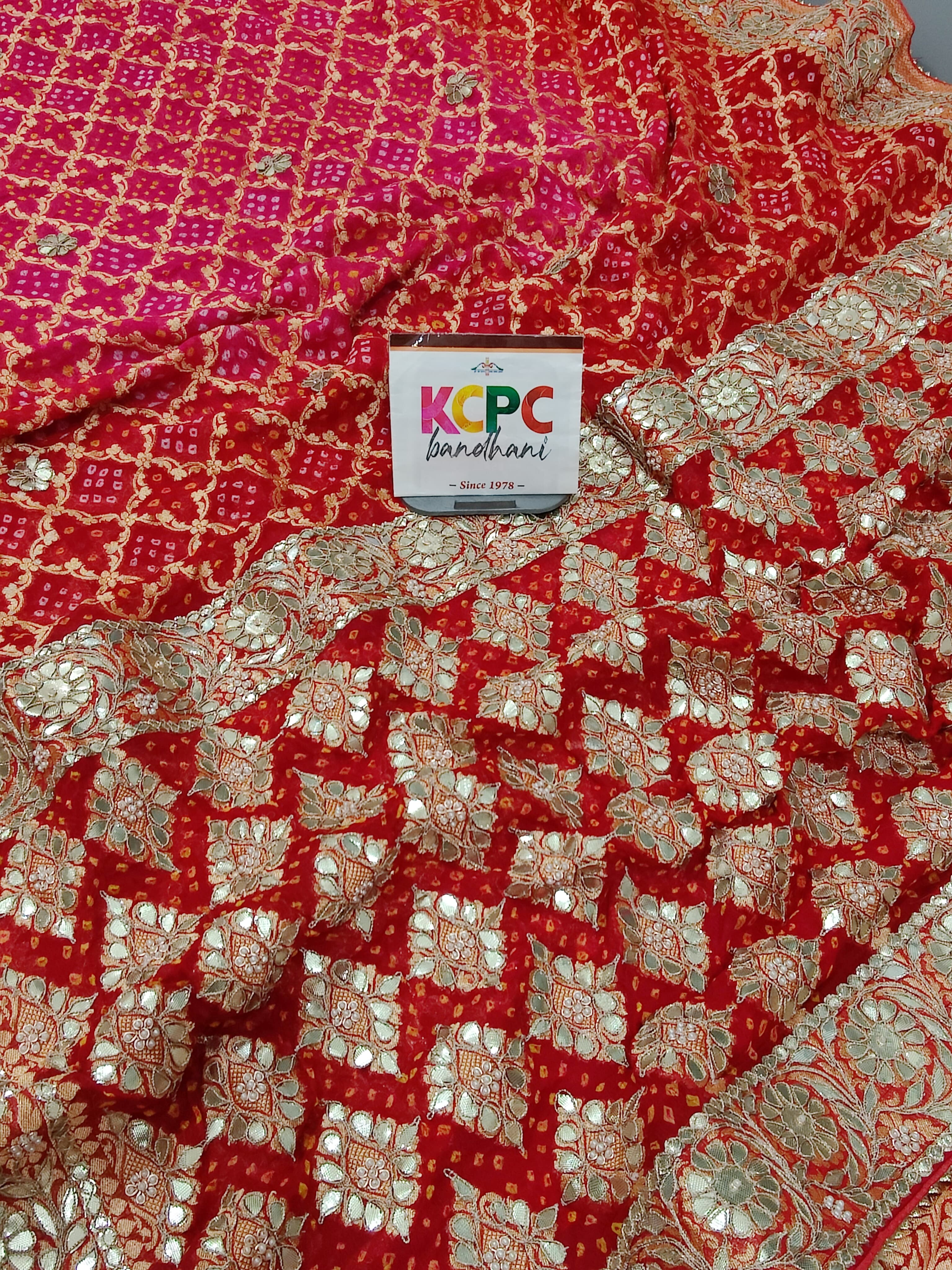 A red georgette saree with gota patti