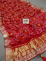 A red and gold silk saree with bandhani style and gota patti 