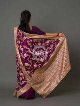 A purple Banarasi saree with floral patterns 