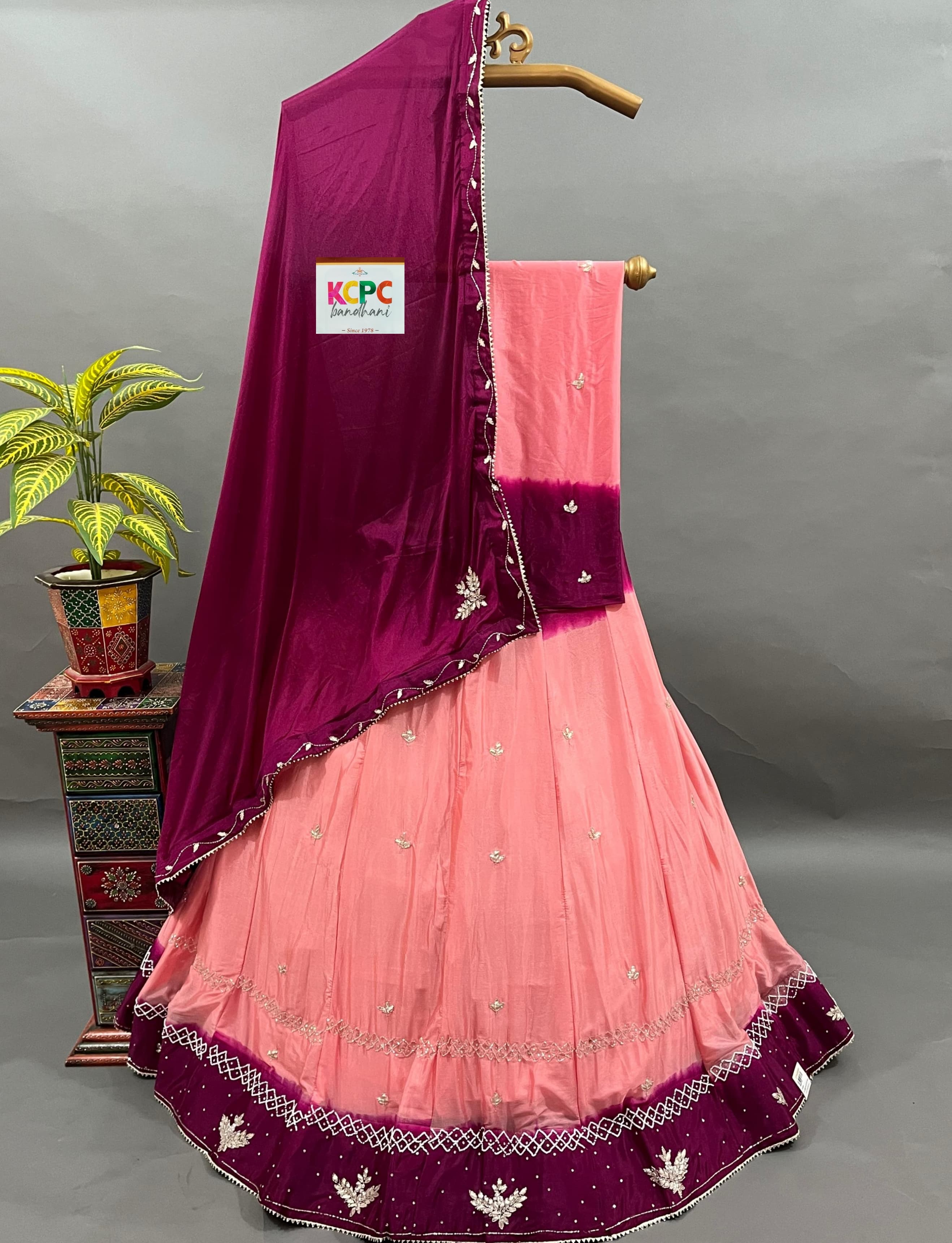 A pink and purple traditional Indian lehenga with cutdana handwork 