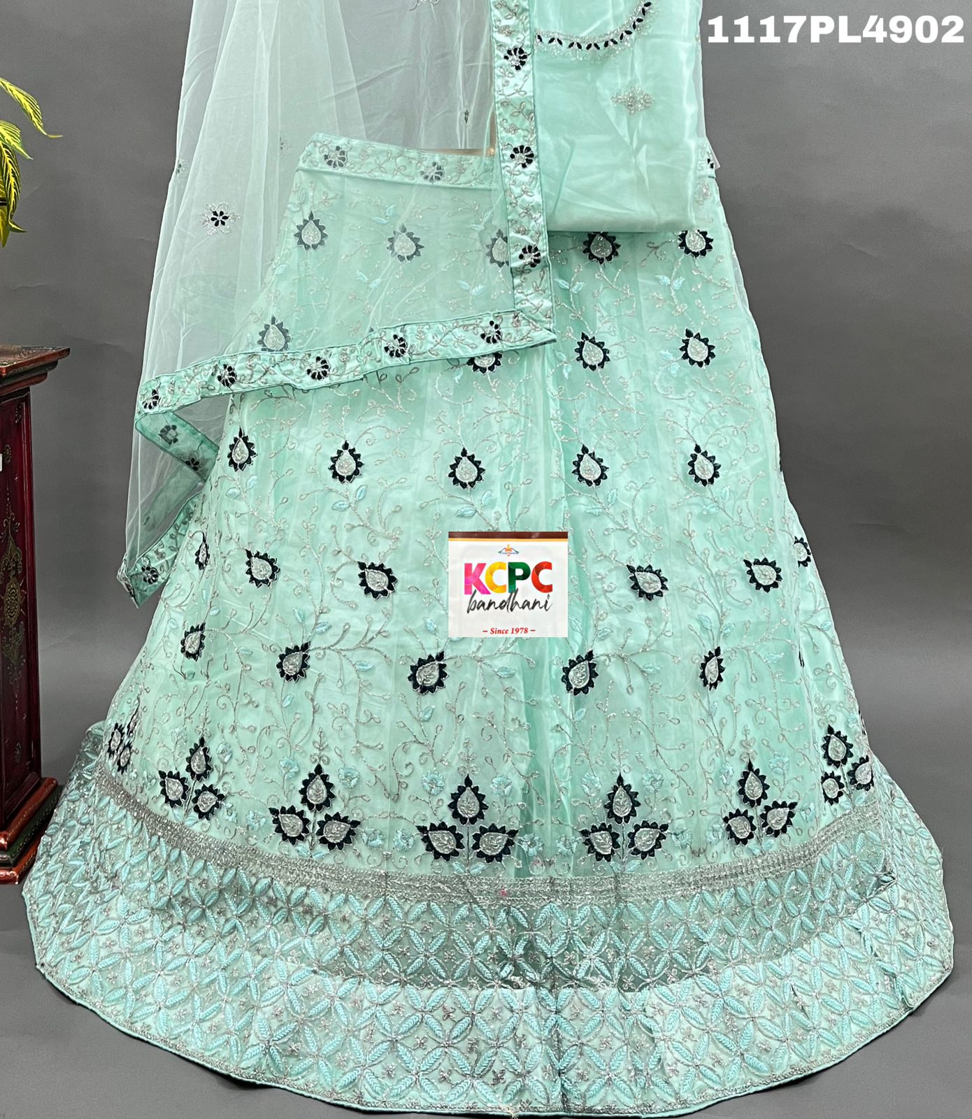 A blue net lehenga set with sequins and embroidery